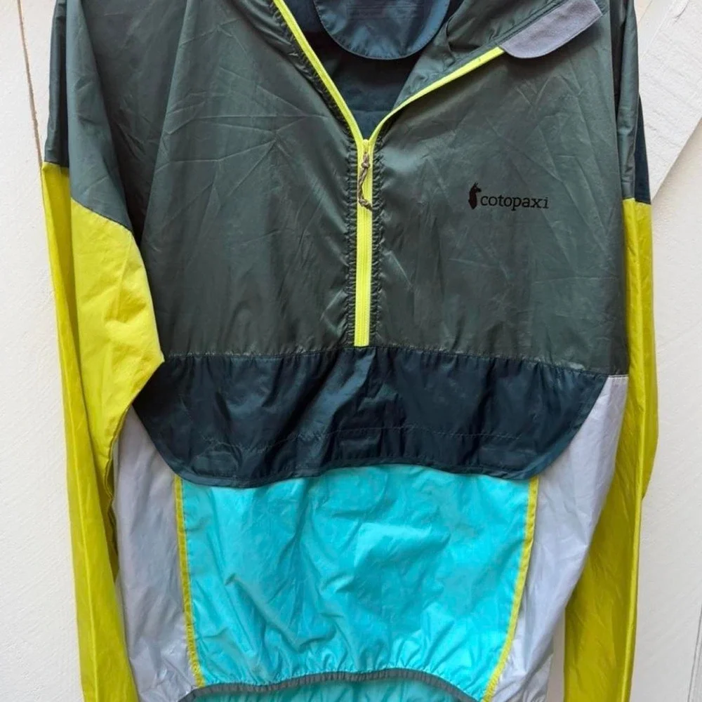 Cotopaxi windbreaker with hood jacket in green, yellow, and teal M